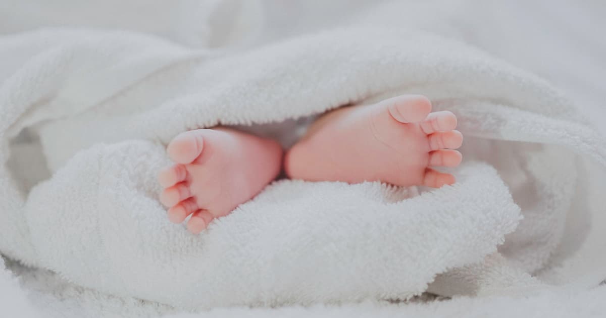 Expecting parents comparing baby registry options on tablet